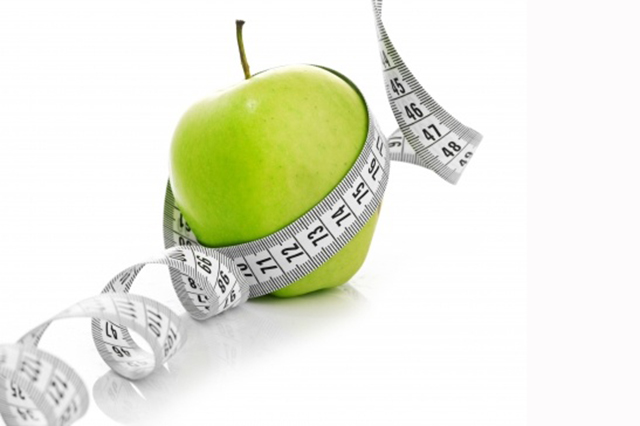 Image of an apple with a tape measure